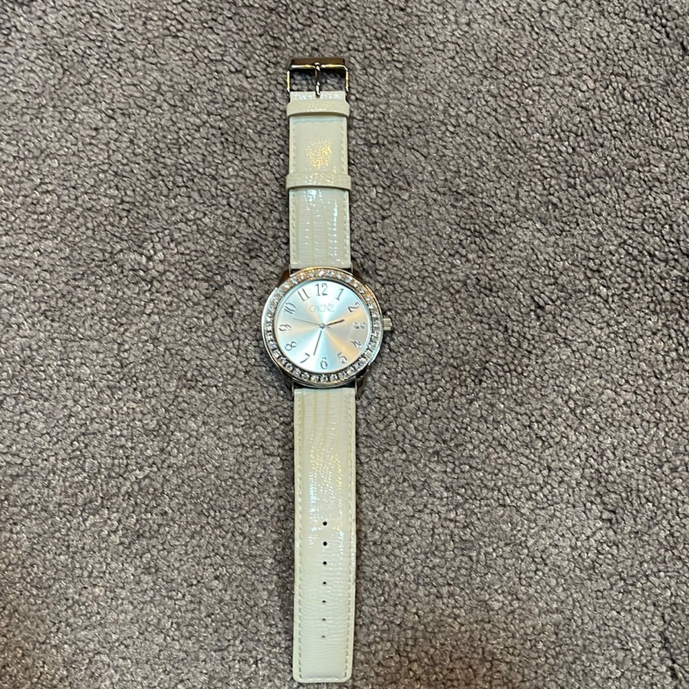 Cache watch with faux diamond around the large face. White leather band.